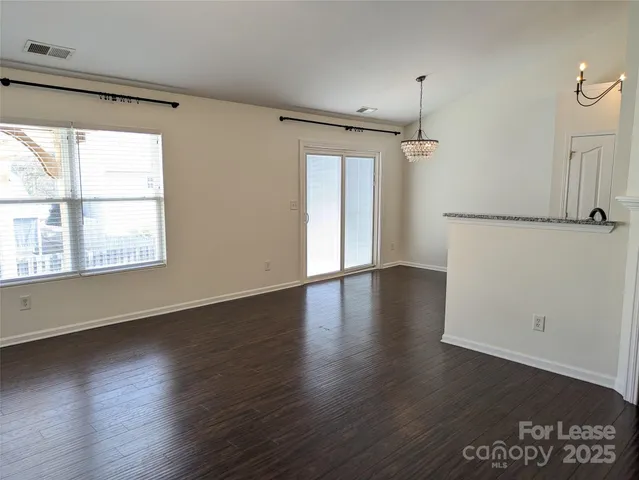 a kitchen with stainless steel appliances granite countertop a refrigerator a stove a sink and a microwave