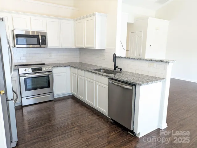 an empty room with wooden floor and door