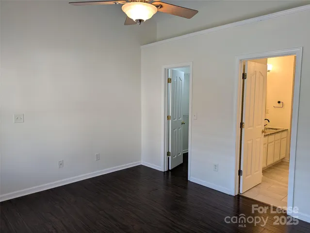 a bathroom with a granite countertop sink a mirror and shower