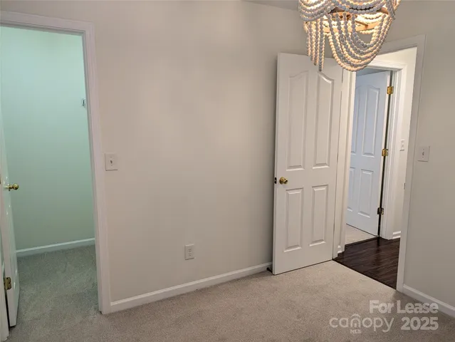 a bathroom with a granite countertop sink a toilet a mirror and shower