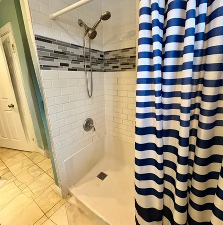 a bathroom with a shower and a sink