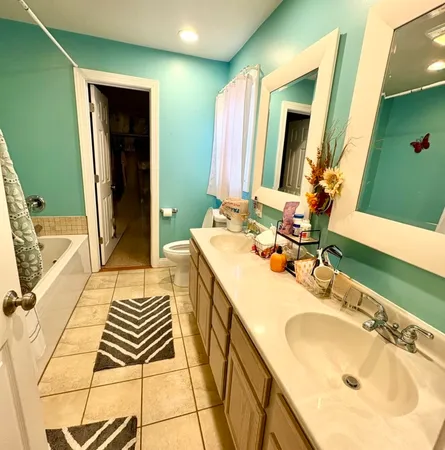 a en suite bathroom with a double vanity sink and a mirror