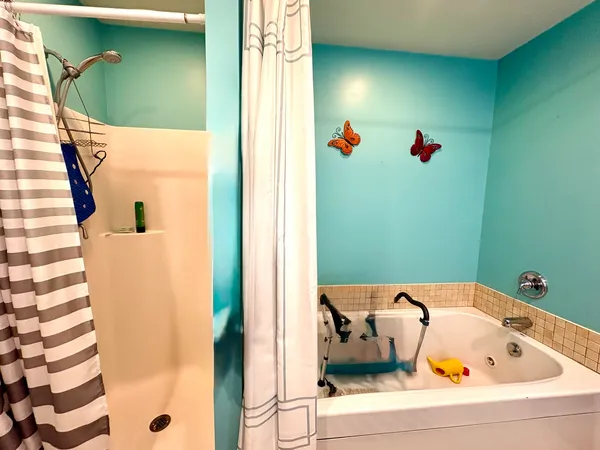 a bathroom with a tub and shower