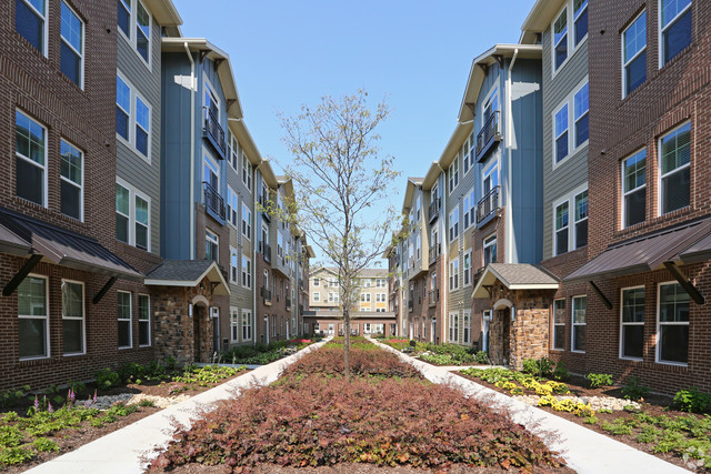 670 East Algonquin Road, Unit 4409 Schaumburg, IL 60173 - Photo 21 of 23 a view of a building with a yard