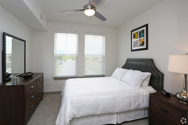 670 East Algonquin Road, Unit 4409 Schaumburg, IL 60173 - Photo 6 of 23 a bedroom with a bed and a dresser