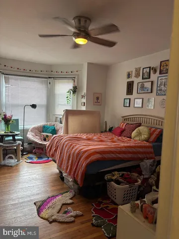 a bedroom with bed and a chandelier