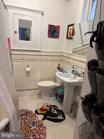 a bathroom with a sink toilet and mirror