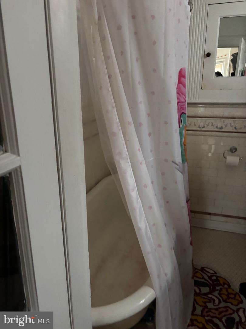 259 South 46th Street, Unit 2F Philadelphia, PA 19139 - Photo 14 of 14 a bathroom with a sink and a mirror