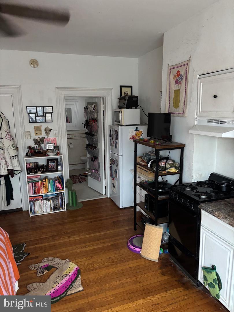 259 South 46th Street, Unit 2F Philadelphia, PA 19139 - Photo 9 of 14 a living room with furniture and a book shelf