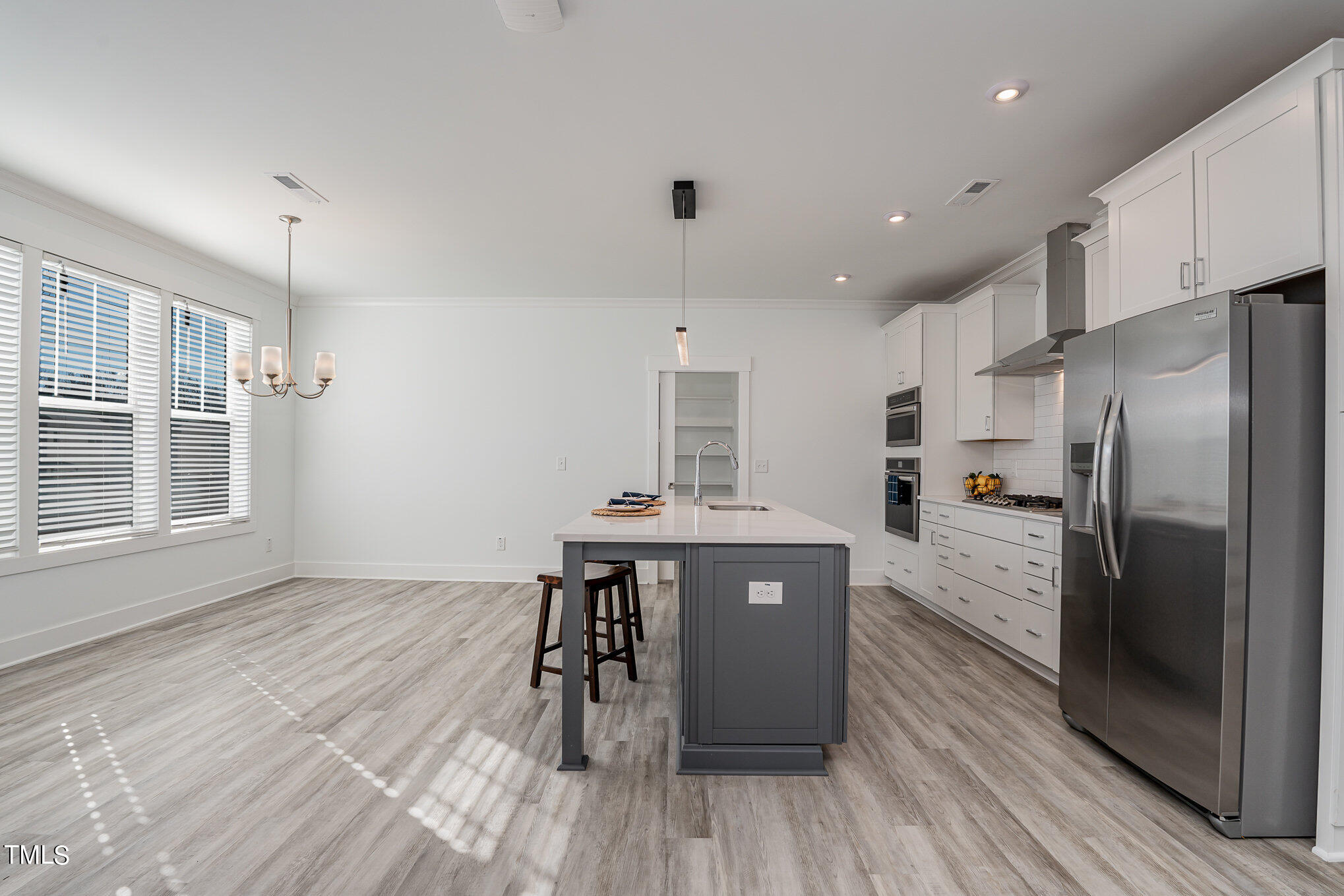 196 DUNLOE Loop Raleigh, NC 27603 - Photo 18 of 43 Huge eat in kitchen with large quartz island and triple windows