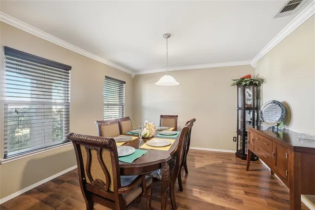 a view of a dining room with furniture and window