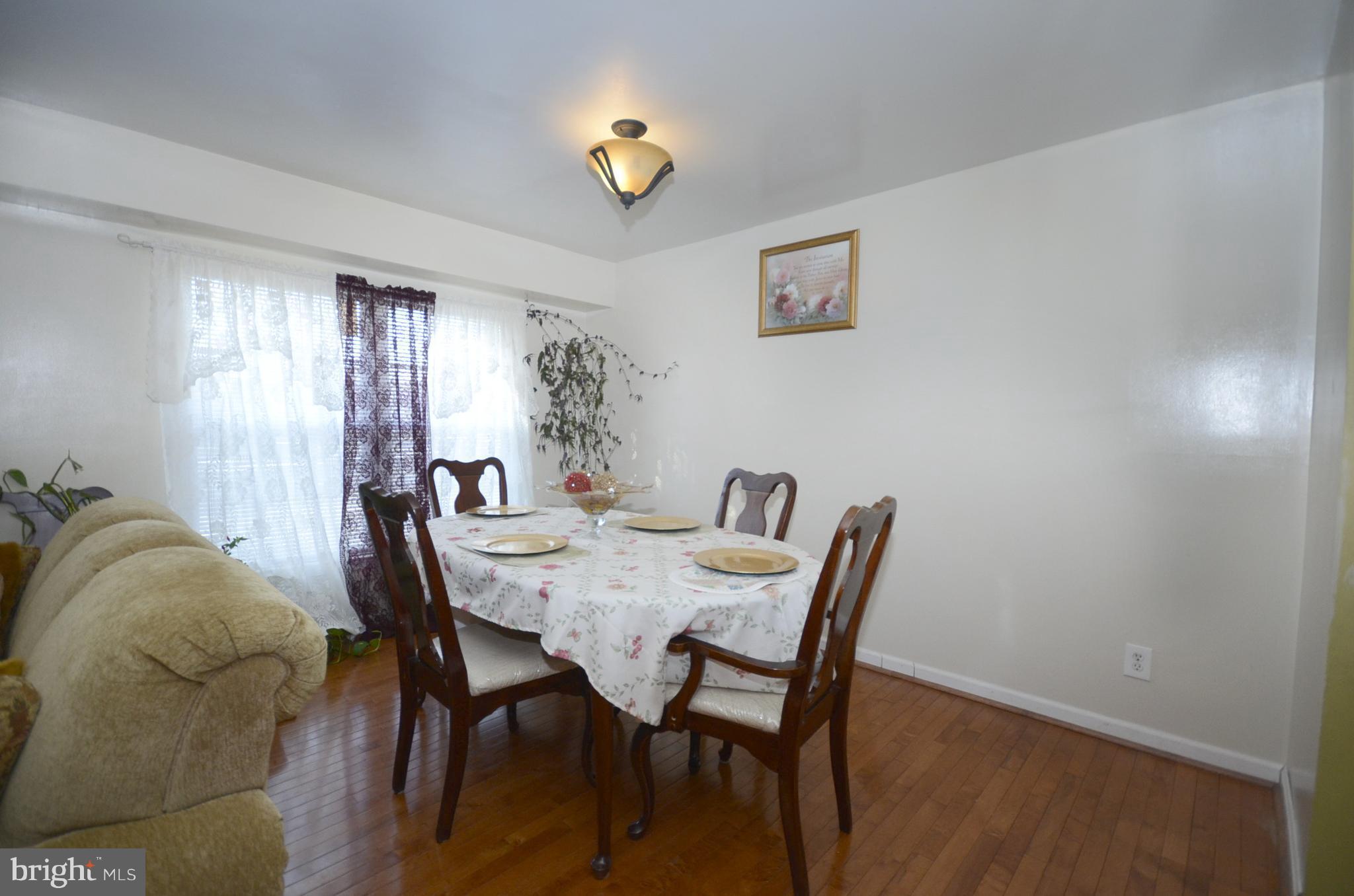 3504 Banquo Drive, Unit 893 Silver Spring, MD 20906 - Photo 11 of 23 a view of a dining room with furniture and chandelier