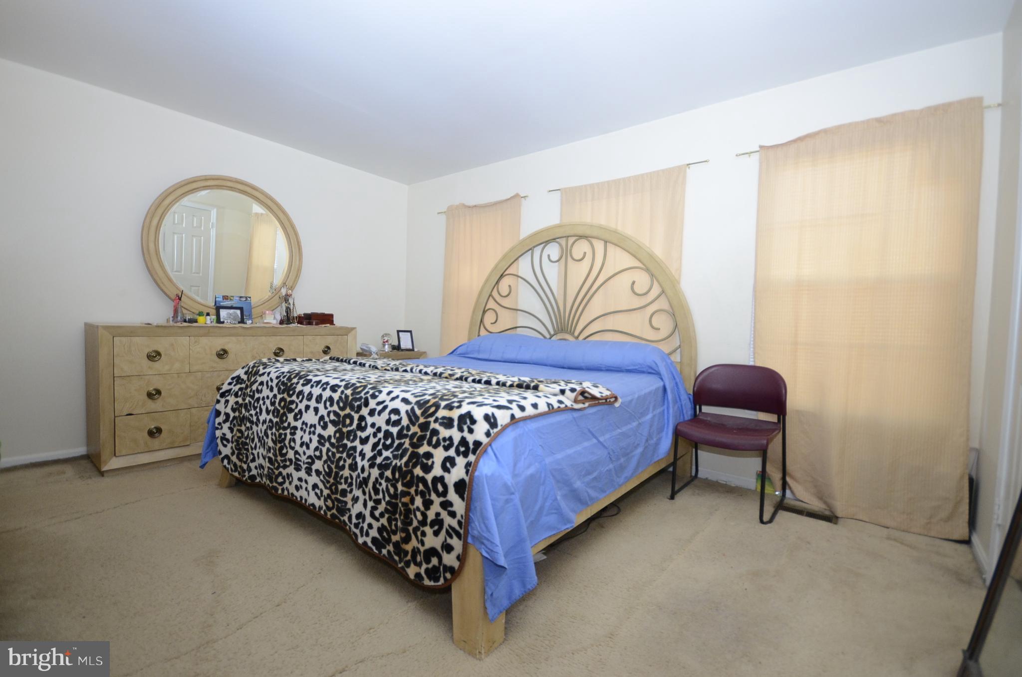 3504 Banquo Drive, Unit 893 Silver Spring, MD 20906 - Photo 12 of 23 a bedroom with a bed and a dresser
