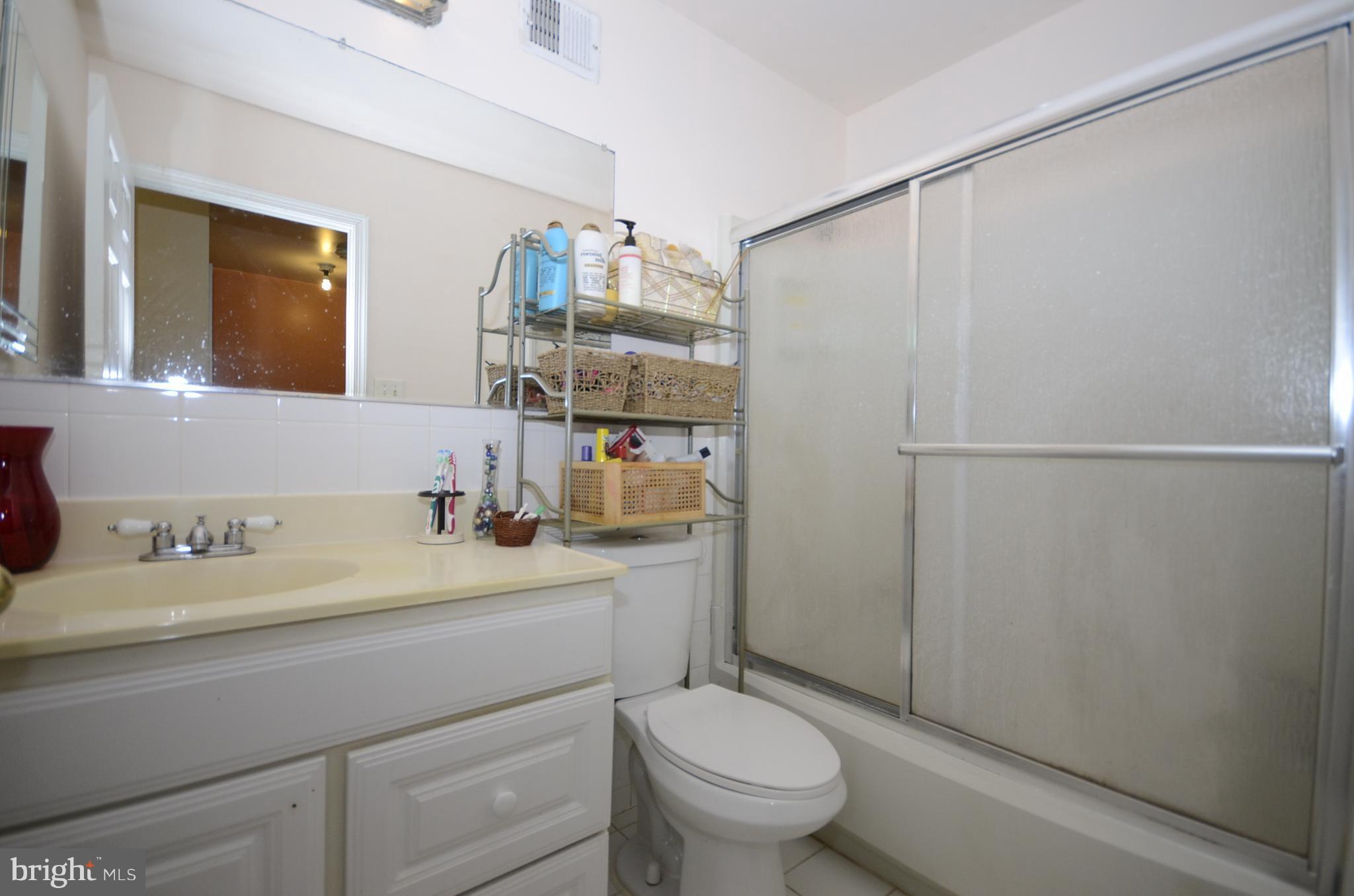 3504 Banquo Drive, Unit 893 Silver Spring, MD 20906 - Photo 13 of 23 a bathroom with a sink a toilet and shower