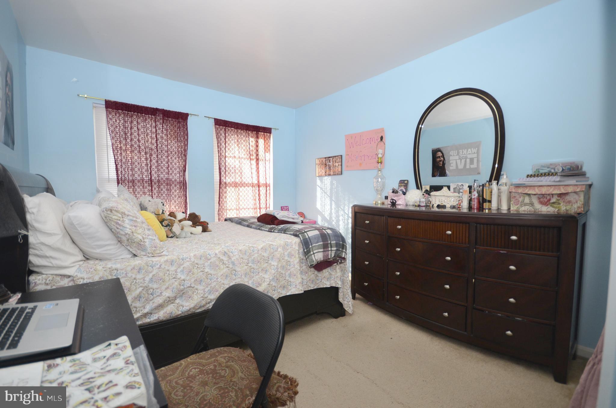 3504 Banquo Drive, Unit 893 Silver Spring, MD 20906 - Photo 15 of 23 a bedroom with a bed and a dresser