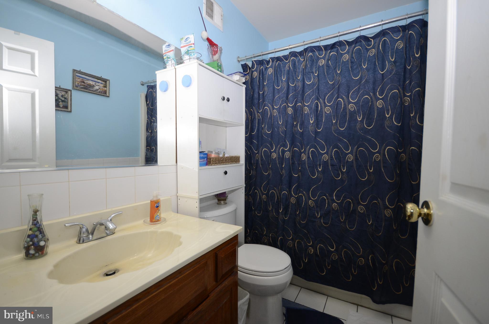 3504 Banquo Drive, Unit 893 Silver Spring, MD 20906 - Photo 16 of 23 a bathroom with a sink toilet and shower
