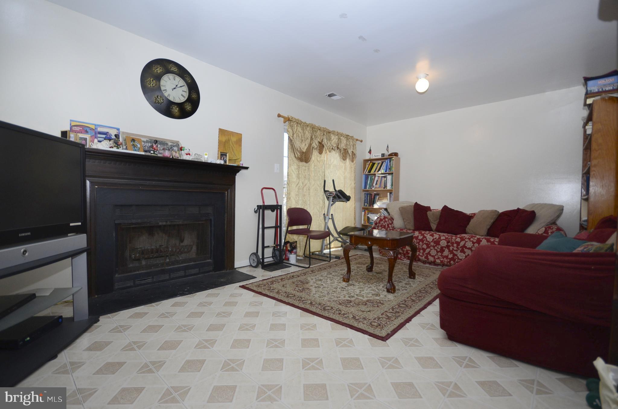 3504 Banquo Drive, Unit 893 Silver Spring, MD 20906 - Photo 18 of 23 a living room with furniture a flat screen tv and a fireplace