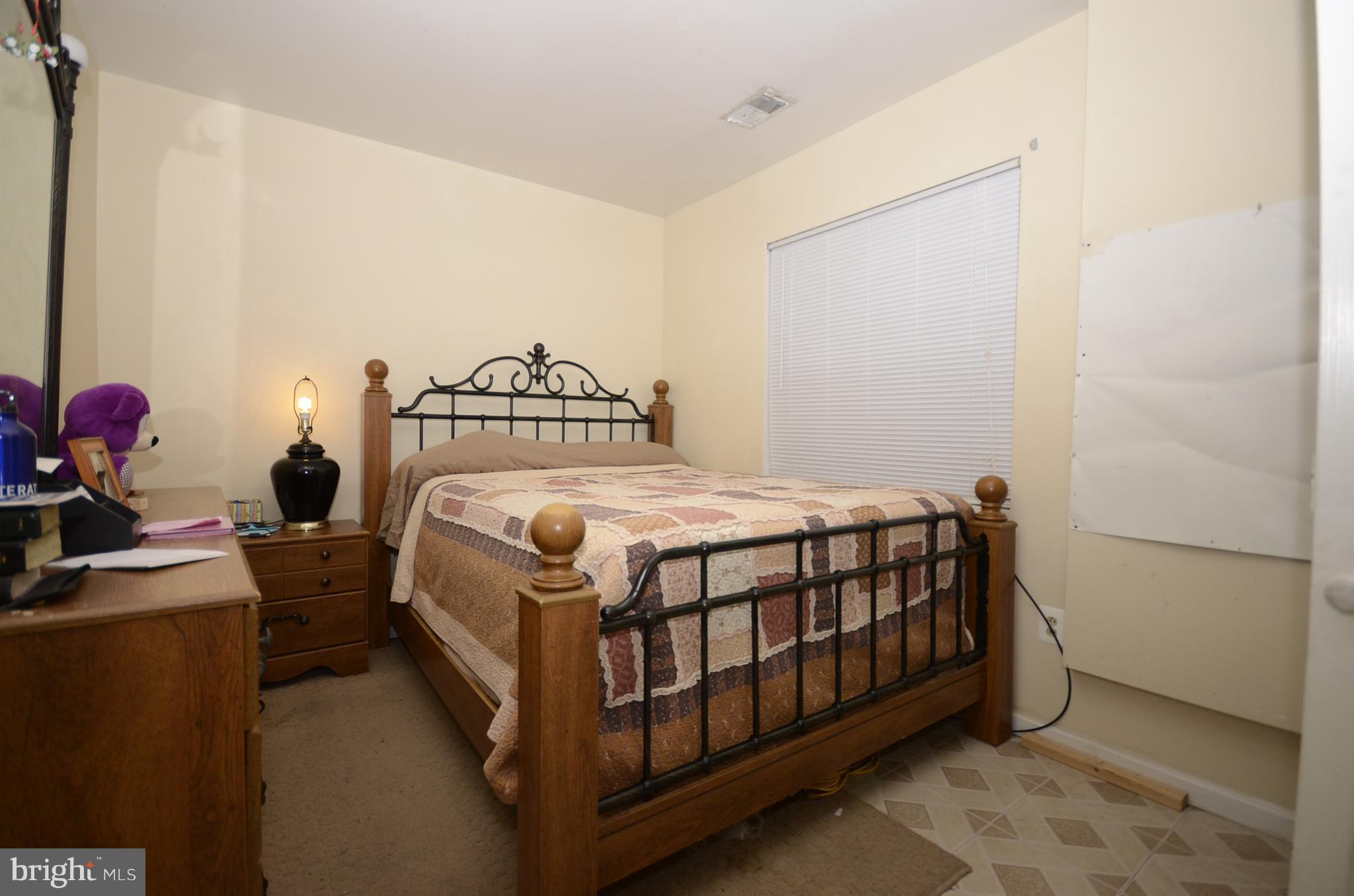 3504 Banquo Drive, Unit 893 Silver Spring, MD 20906 - Photo 19 of 23 a bedroom with a bed and a chandelier