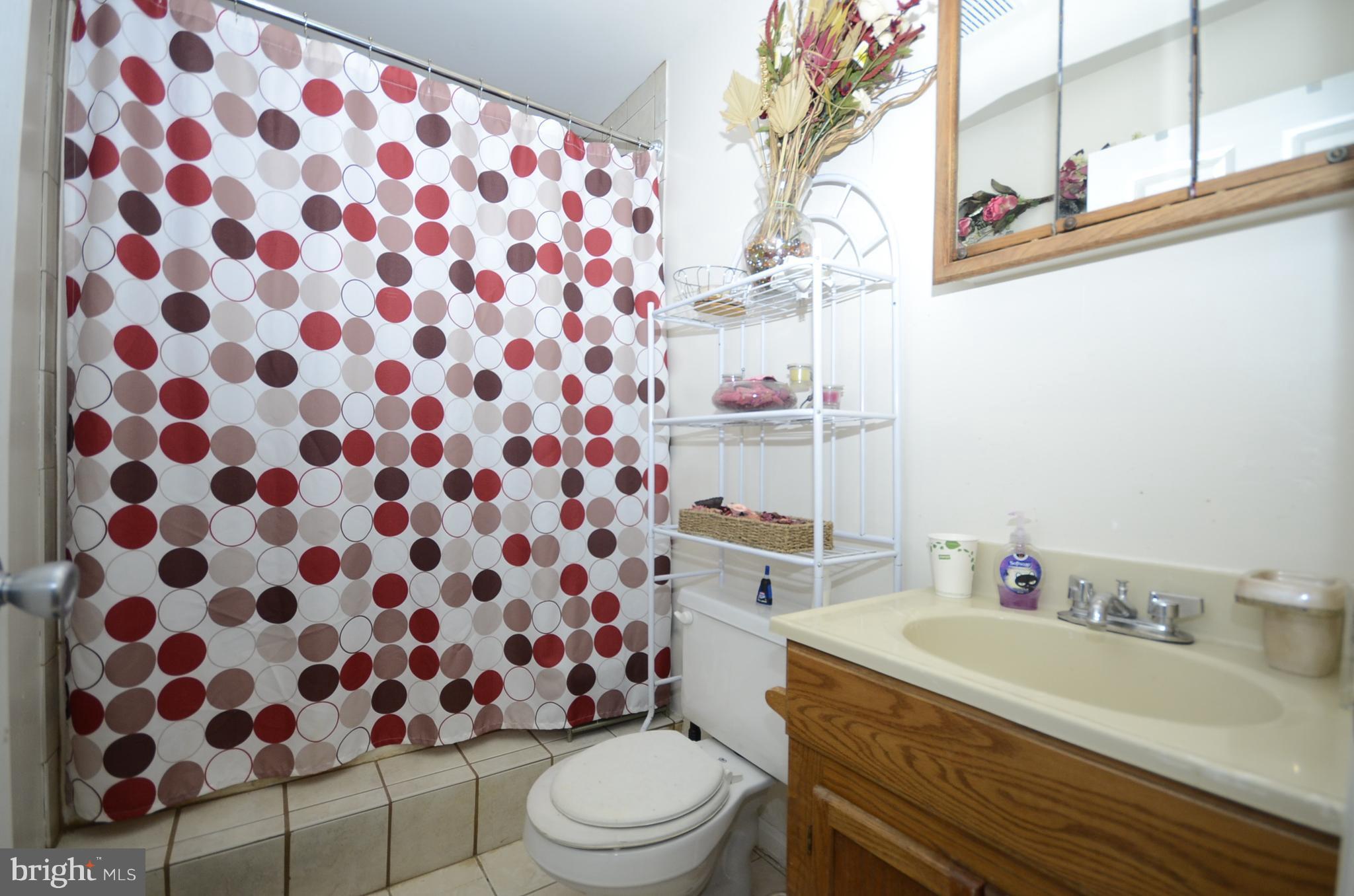 3504 Banquo Drive, Unit 893 Silver Spring, MD 20906 - Photo 20 of 23 a bathroom with a sink toilet and shower