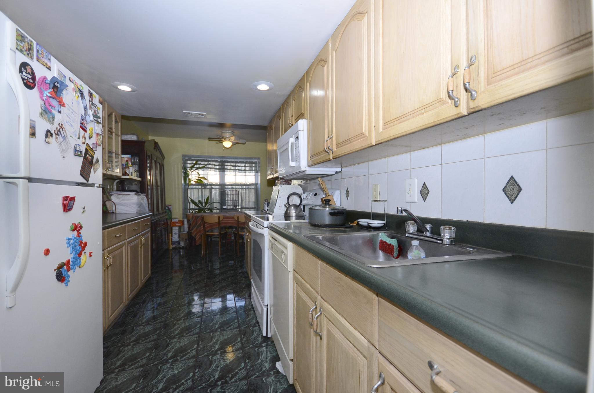 3504 Banquo Drive, Unit 893 Silver Spring, MD 20906 - Photo 3 of 23 a kitchen with stainless steel appliances granite countertop a sink stove and refrigerator