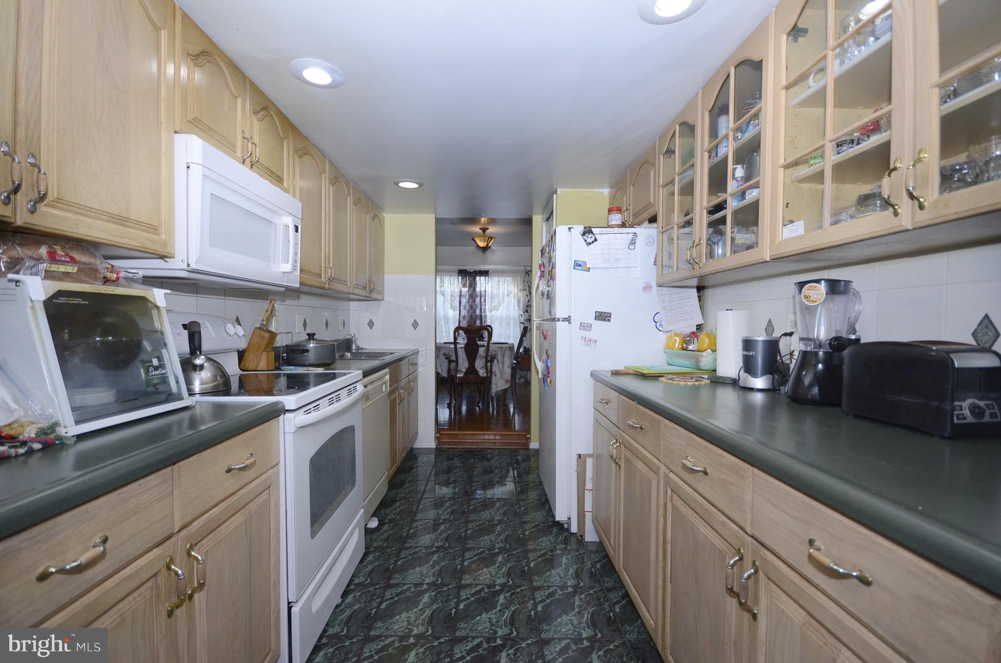 3504 Banquo Drive, Unit 893 Silver Spring, MD 20906 - Photo 4 of 23 a kitchen with stainless steel appliances granite countertop lots of counter top space and cabinets
