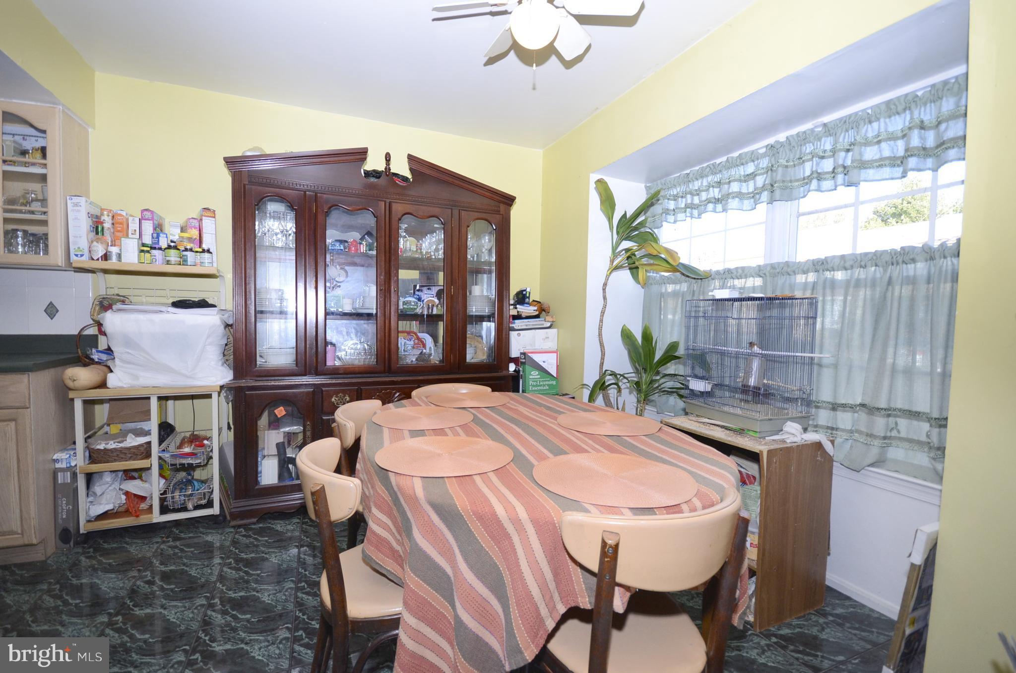 3504 Banquo Drive, Unit 893 Silver Spring, MD 20906 - Photo 5 of 23 a dining room with a table and chairs