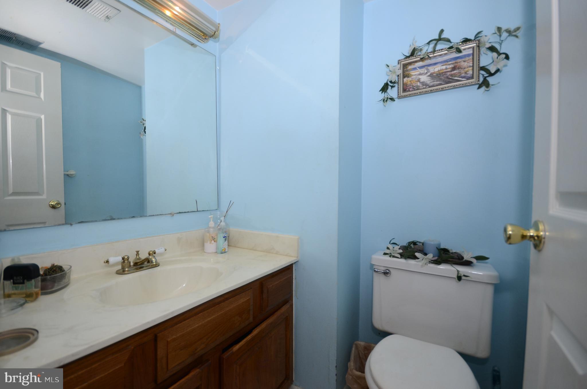 3504 Banquo Drive, Unit 893 Silver Spring, MD 20906 - Photo 7 of 23 a bathroom with a sink toilet and mirror