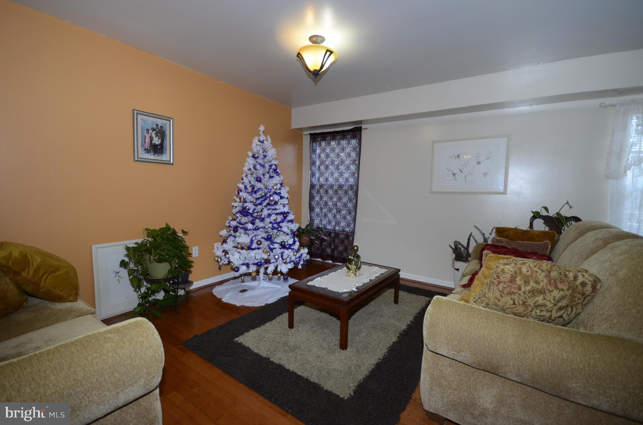 3504 Banquo Drive, Unit 893 Silver Spring, MD 20906 - Photo 9 of 23 a living room with furniture and a lamp