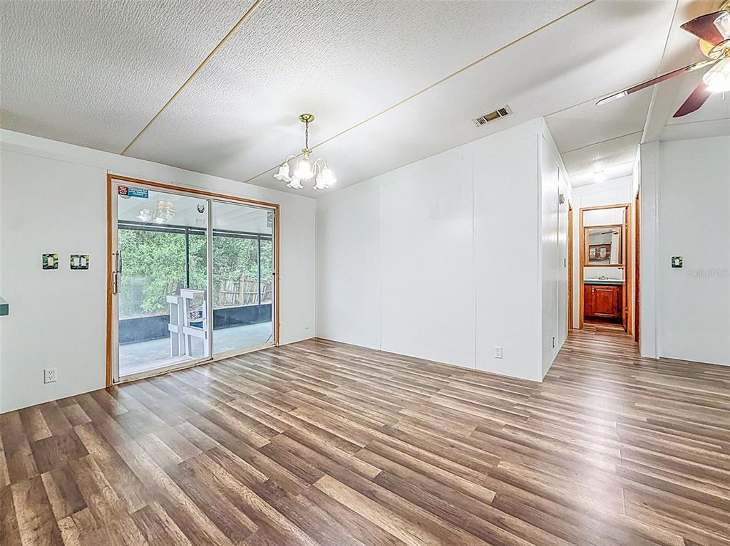 1819 Sinclair Hills Road Lutz, FL 33549 - Photo 21 of 60 a view of empty room with wooden floor and fan