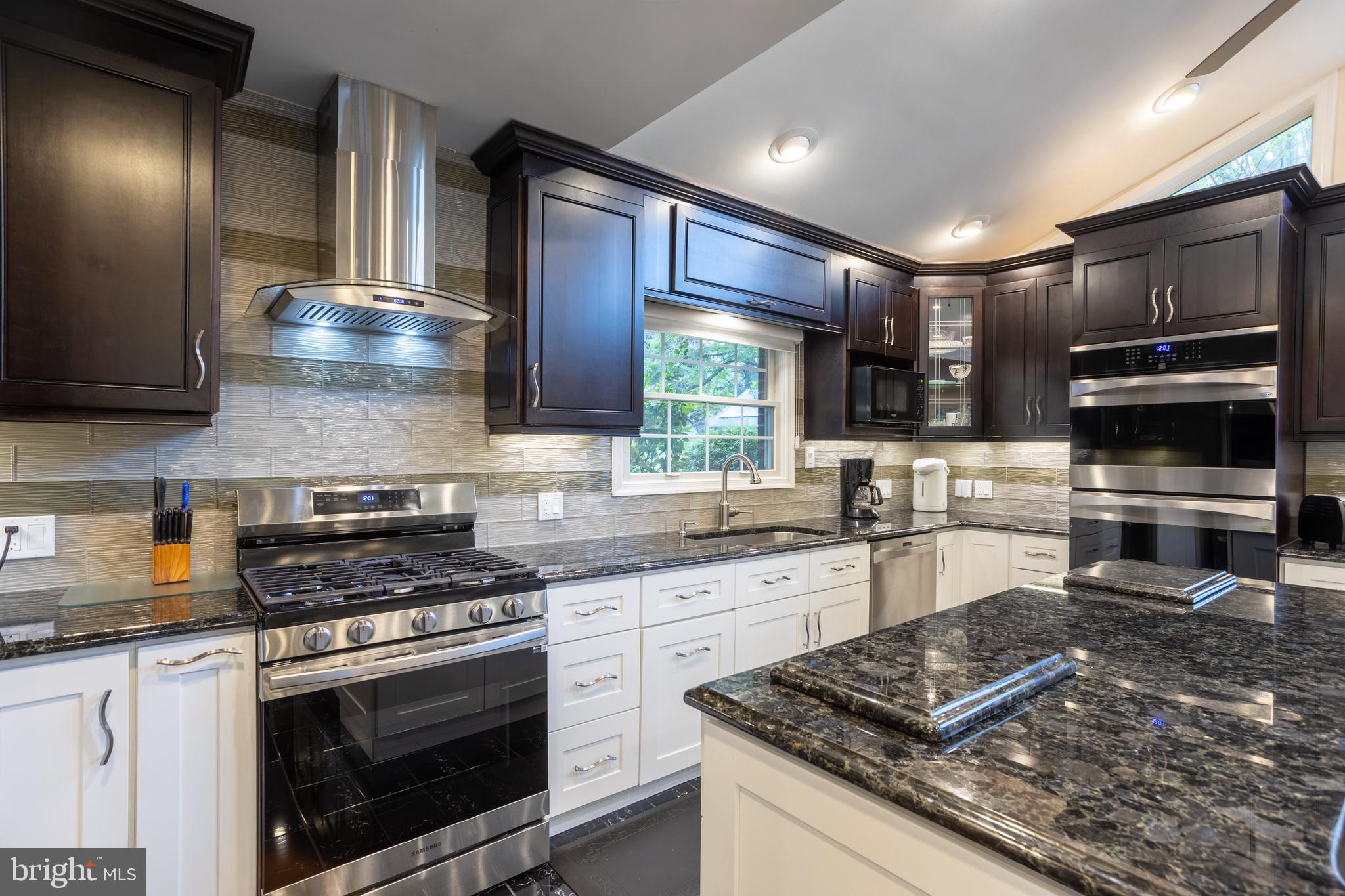 7908 Ivy Lane Baltimore, MD 21208 - Photo 18 of 90 a kitchen with stainless steel appliances granite countertop a stove and a sink