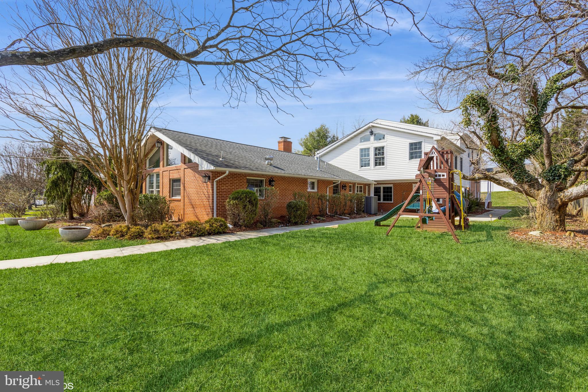 7908 Ivy Lane Baltimore, MD 21208 - Photo 2 of 90 a front view of a house with a yard and green space