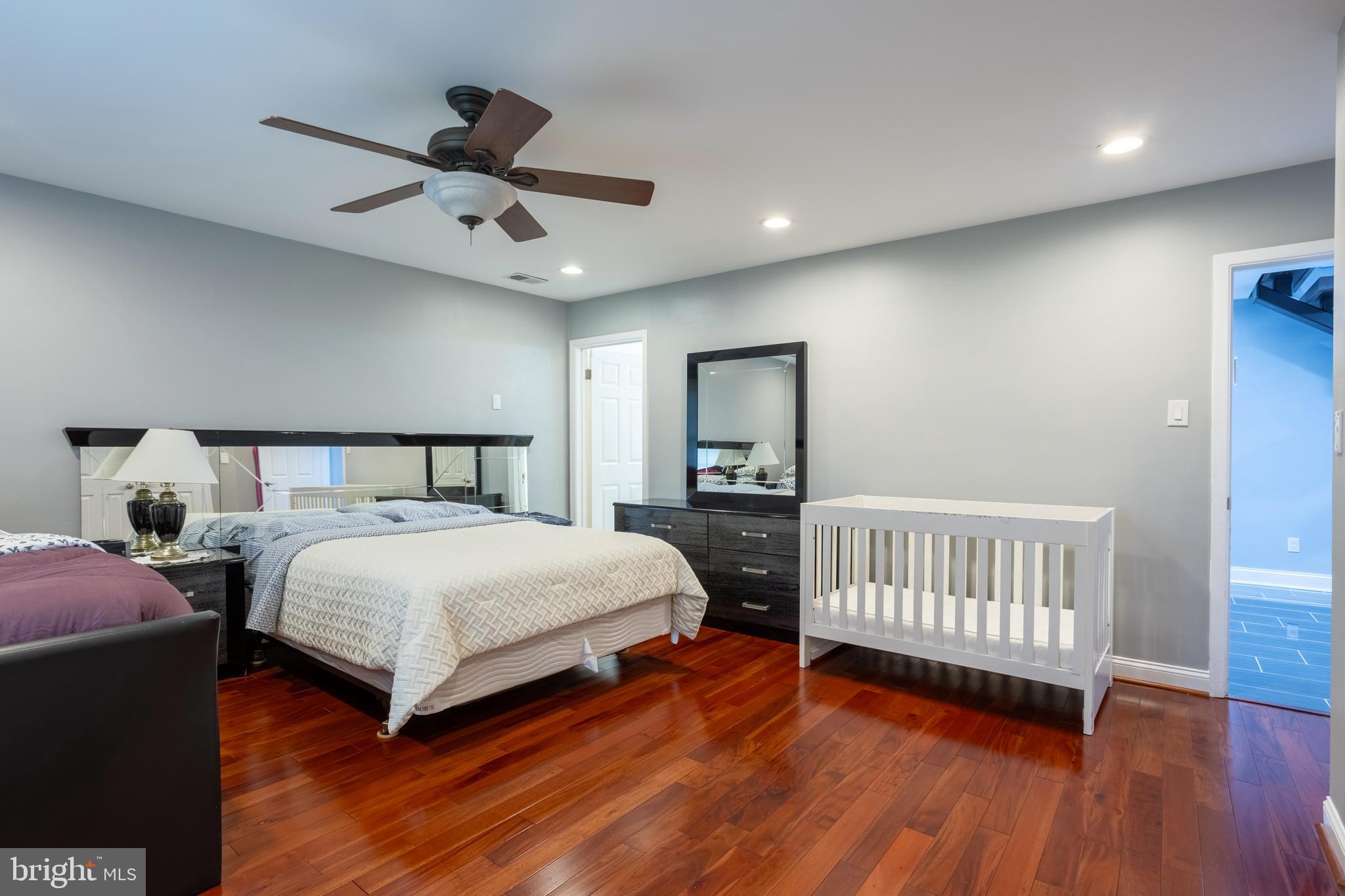 7908 Ivy Lane Baltimore, MD 21208 - Photo 32 of 90 a bedroom with a bed and wooden floor