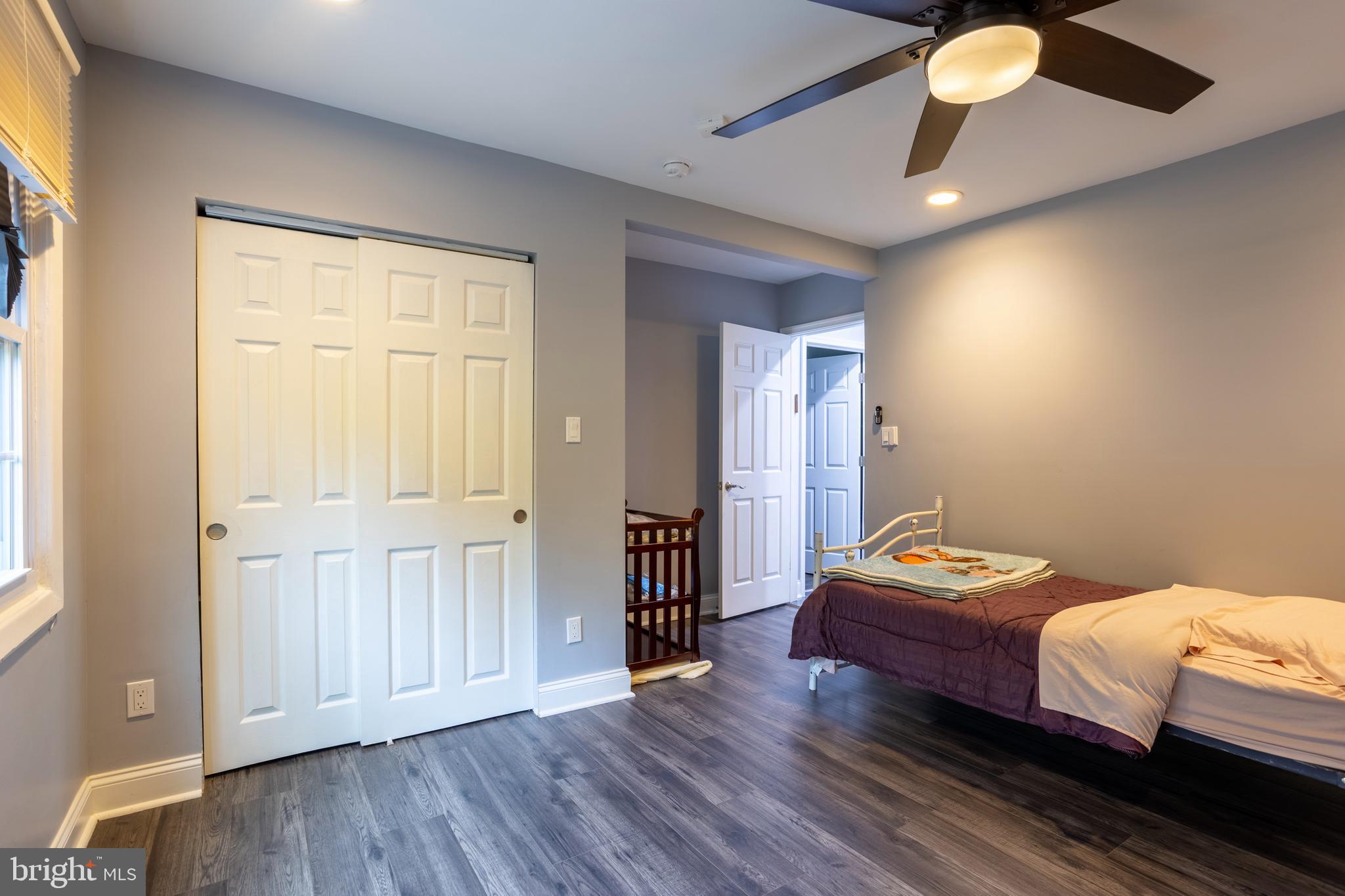 7908 Ivy Lane Baltimore, MD 21208 - Photo 38 of 90 a bedroom with a bed and a chandelier