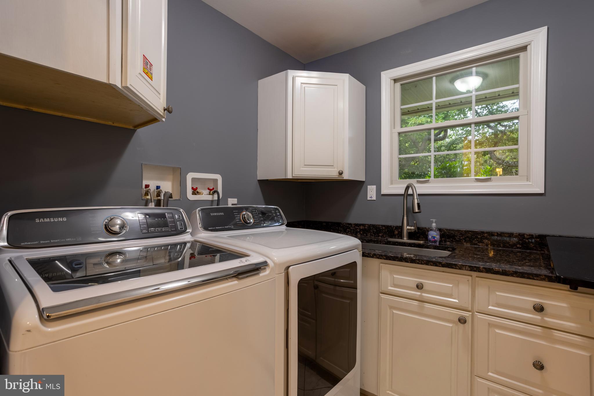 7908 Ivy Lane Baltimore, MD 21208 - Photo 41 of 90 a kitchen with granite countertop a sink stove and cabinets