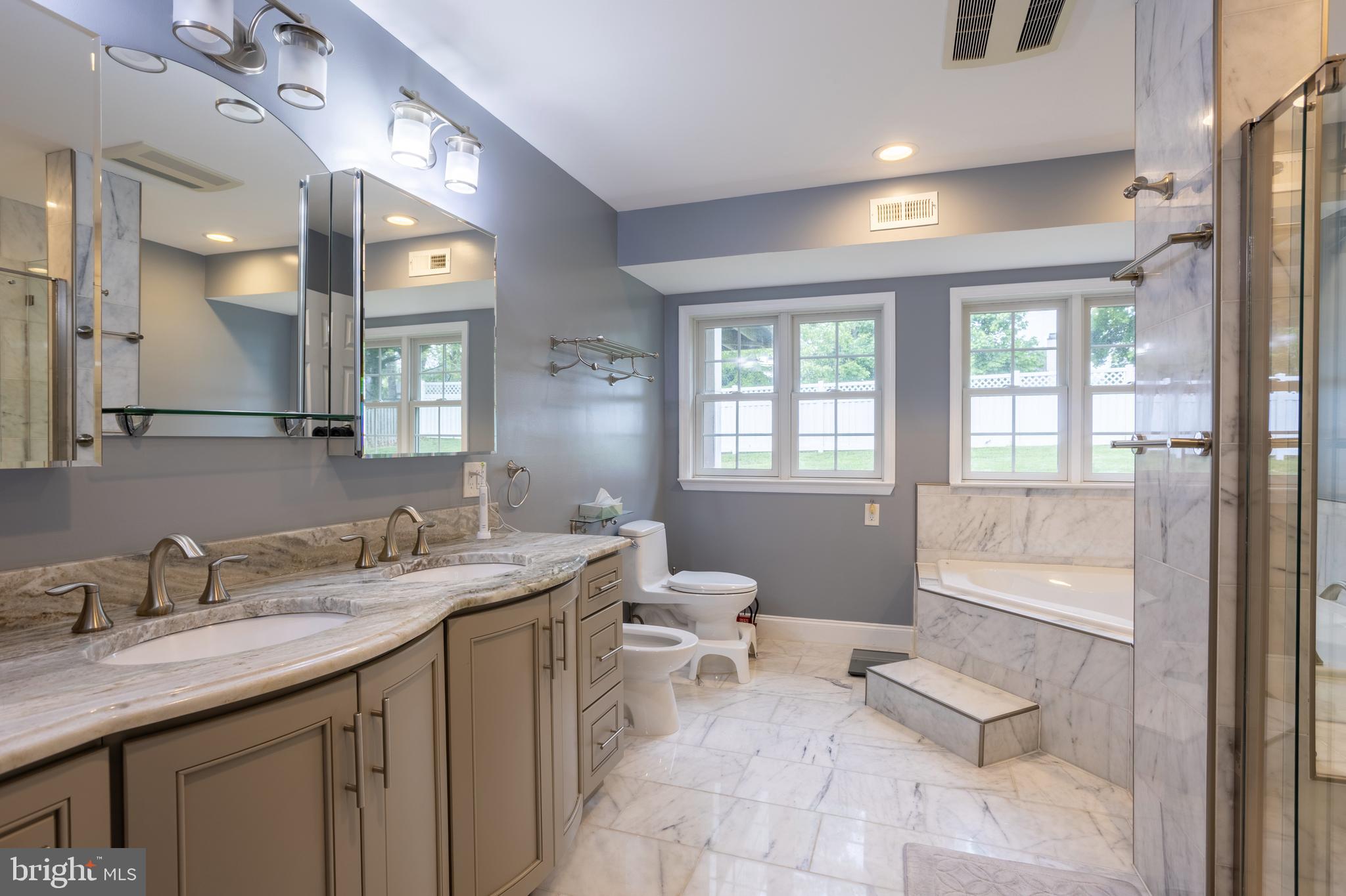 7908 Ivy Lane Baltimore, MD 21208 - Photo 48 of 90 a spacious bathroom with a granite countertop sink toilet and a mirror