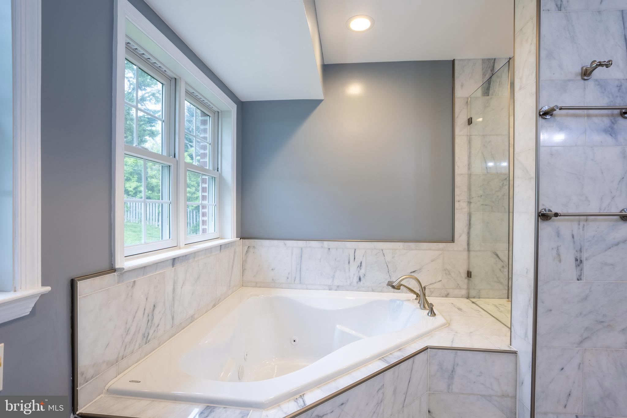 7908 Ivy Lane Baltimore, MD 21208 - Photo 49 of 90 a bath tub sitting in a bathroom next to a window