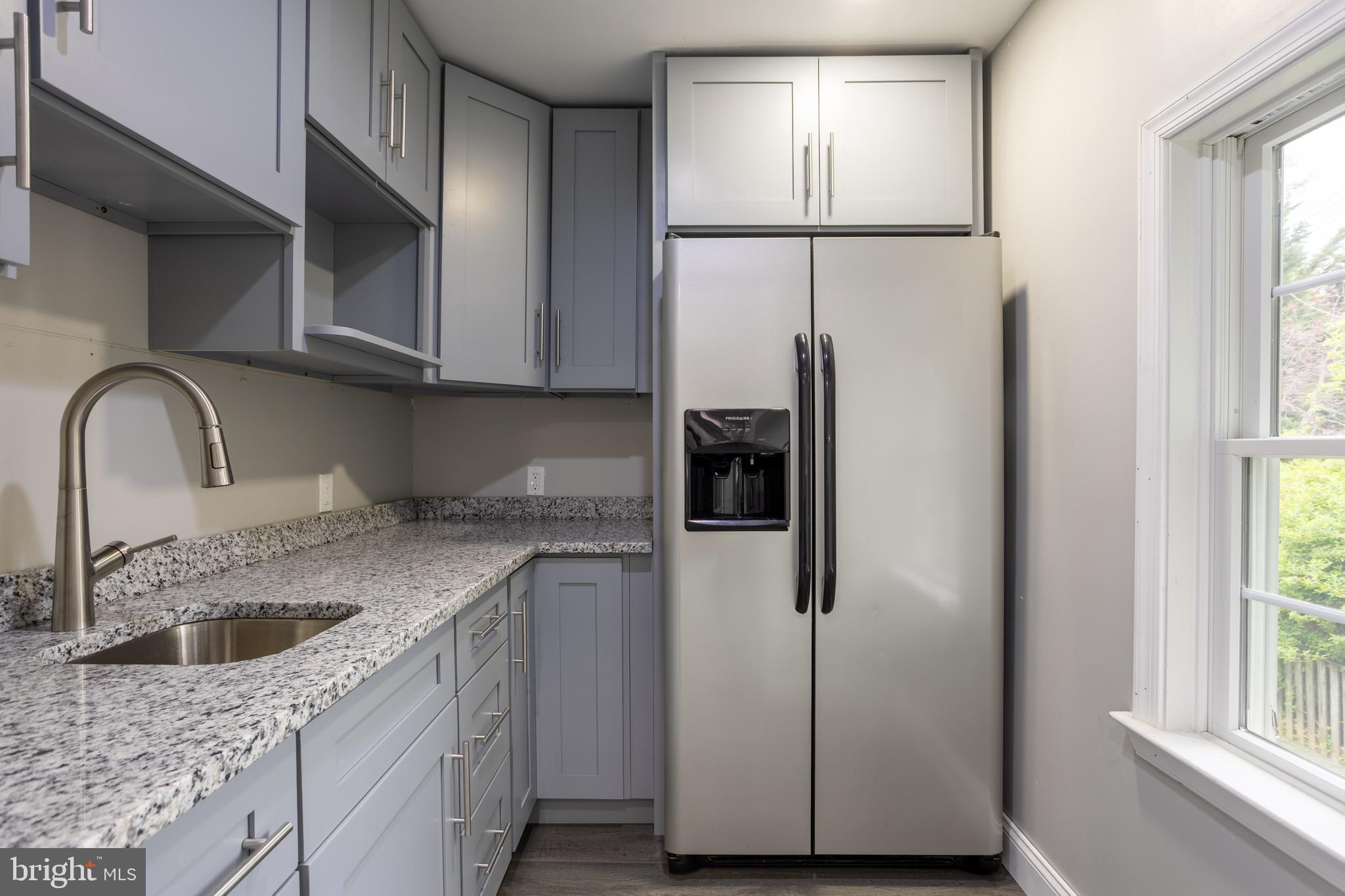 7908 Ivy Lane Baltimore, MD 21208 - Photo 58 of 90 a kitchen with a refrigerator sink and cabinets