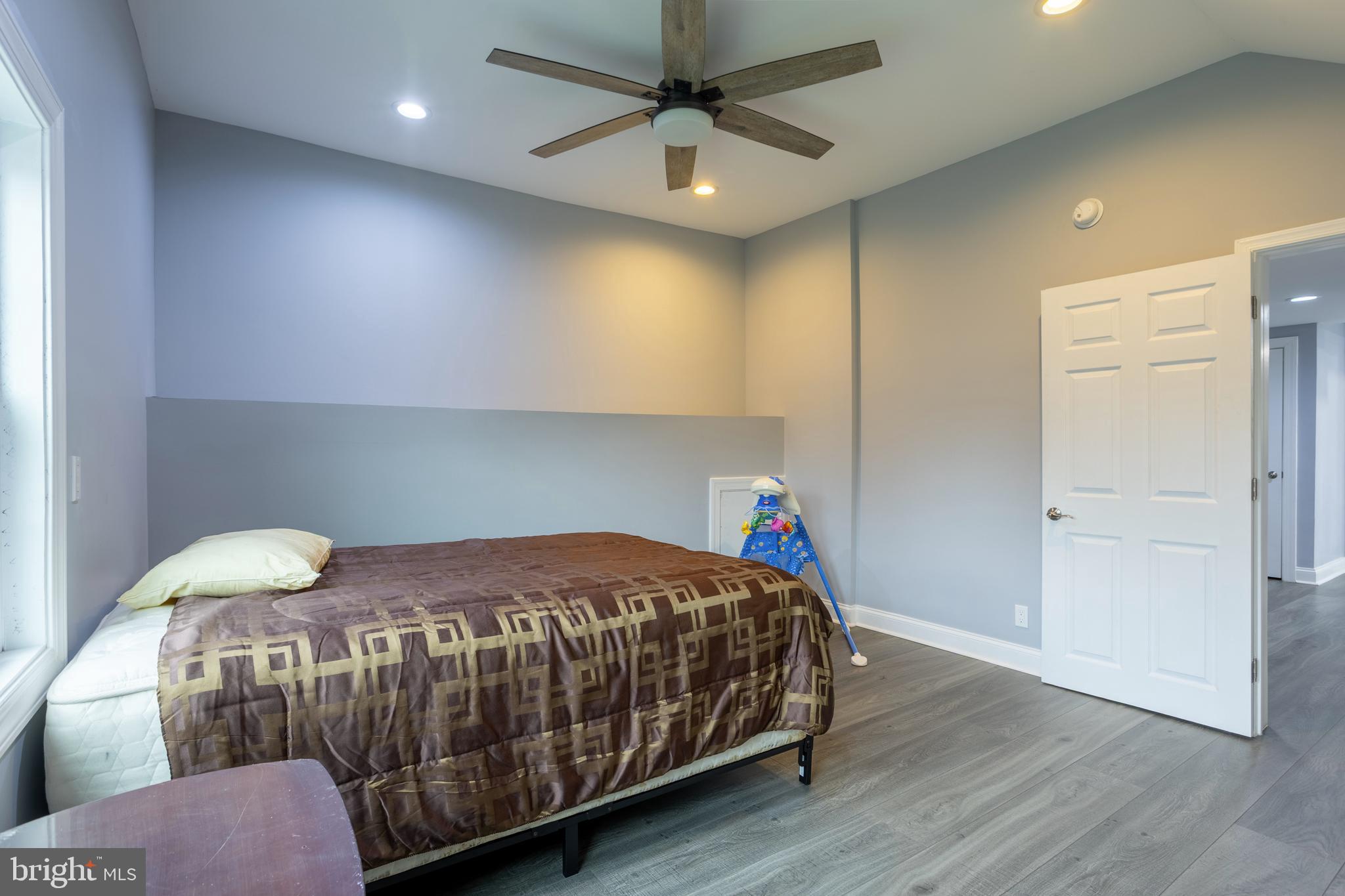 7908 Ivy Lane Baltimore, MD 21208 - Photo 61 of 90 a bedroom with a bed and a chandelier