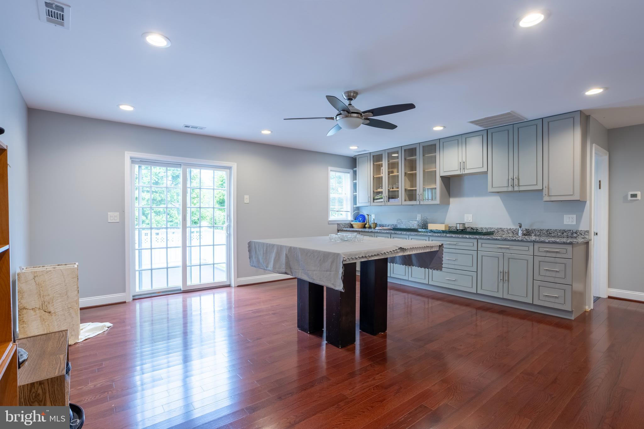 7908 Ivy Lane Baltimore, MD 21208 - Photo 65 of 90 a kitchen with granite countertop a sink cabinets and wooden floor