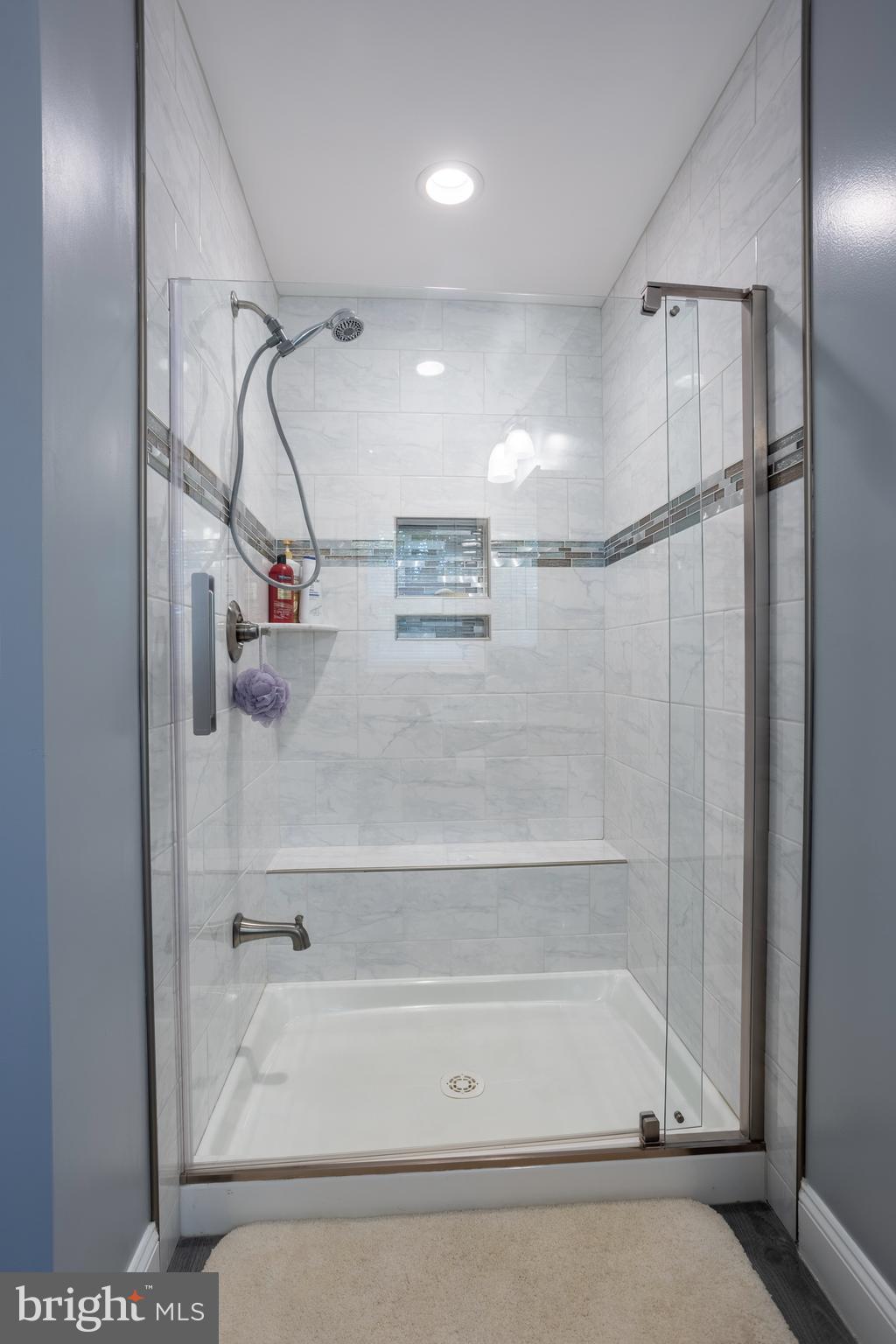 7908 Ivy Lane Baltimore, MD 21208 - Photo 72 of 90 a bathroom with a bathtub and a shower