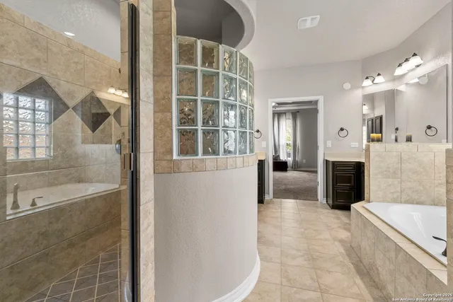 a bathroom with a tub shower and sink