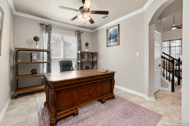 a view of a workspace with furniture and a window