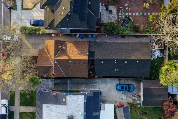an aerial view of multiple houses with a yard