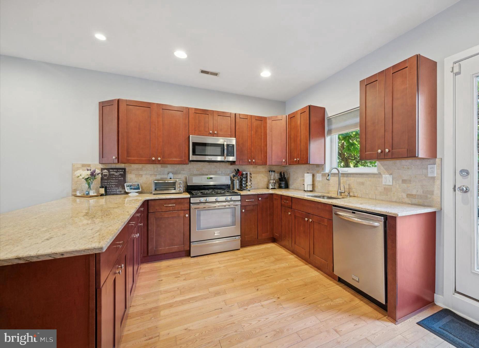 4128 Apple Street Philadelphia, PA 19127 - Photo 8 of 25 a kitchen with stainless steel appliances granite countertop a stove sink microwave and cabinets