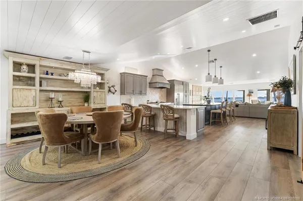 a large kitchen with a table and chairs