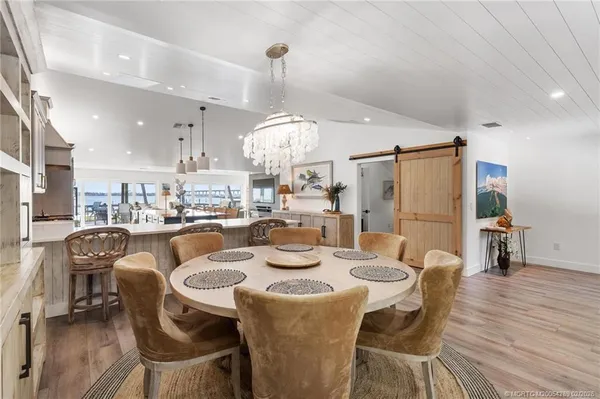 a kitchen with kitchen island a counter top space a sink stainless steel appliances and cabinets
