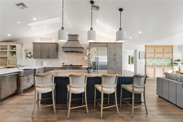 a kitchen with stainless steel appliances granite countertop a stove and a refrigerator