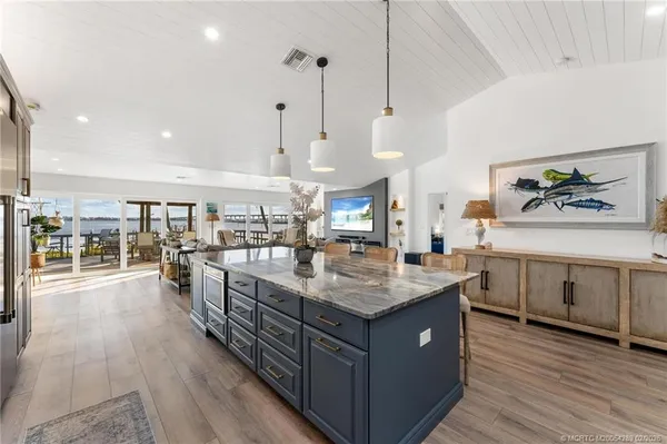 a kitchen with stainless steel appliances granite countertop a refrigerator and a sink
