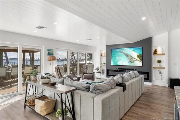 a spacious bedroom with a bed and a flat screen tv