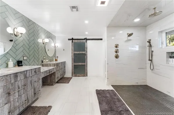 a bathroom with a shower and a potted plant